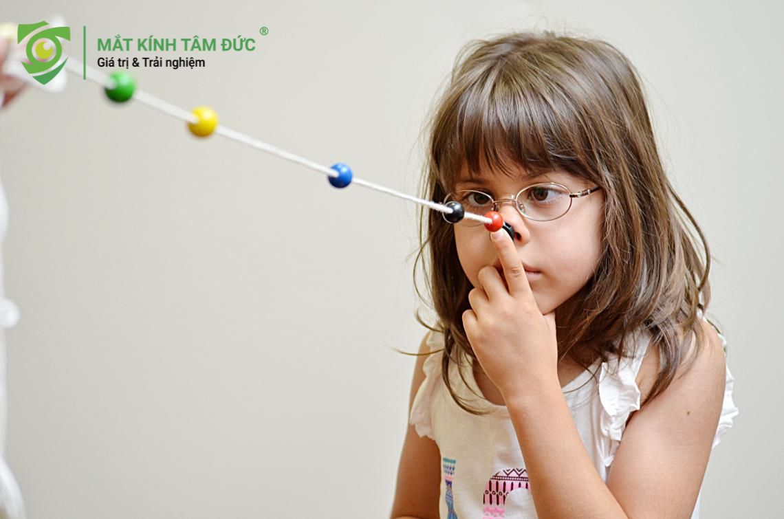 Sử dụng một sợi dây dài có xâu các hạt màu để cải thiện mắt lác